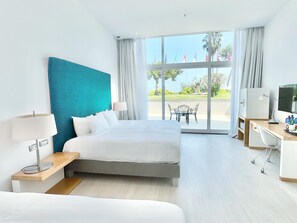 Family Triple Room, Garden View | Minibar, in-room safe, desk, laptop workspace