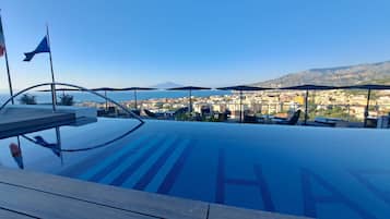 Indoor pool, seasonal outdoor pool, pool umbrellas, pool loungers