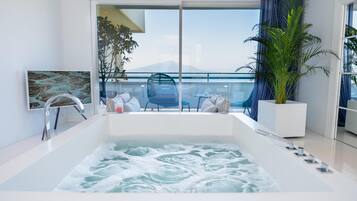 Suite, 1 King Bed (Surya) | Bathroom | Combined shower/bathtub, free toiletries, hair dryer, bidet