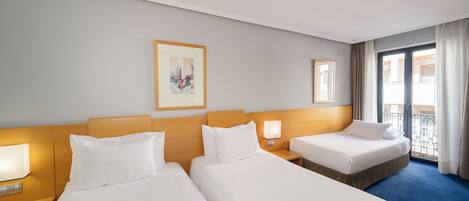 A hotel room with two beds, a nightstand with a lamp, a painting on the wall, and a balcony with curtains.