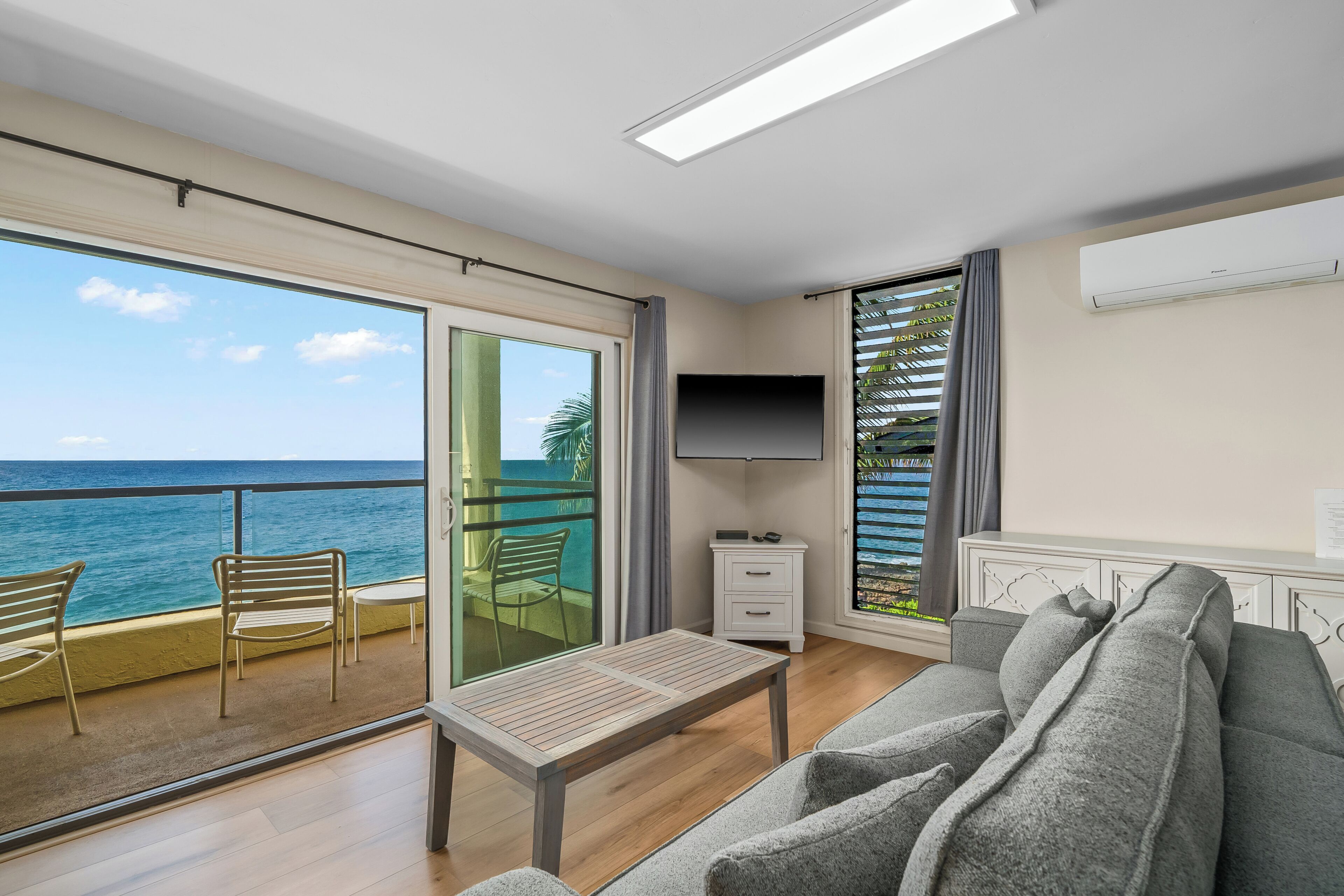 Deluxe Condo, 1 Bedroom, Oceanfront | Living room | 65-inch flat-screen TV with cable channels
