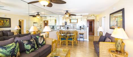 A spacious living room with a sofa, coffee table, and dining area.