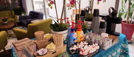 A coffee bar setup with various coffee-making equipment, utensils, and a selection of coffee pods.