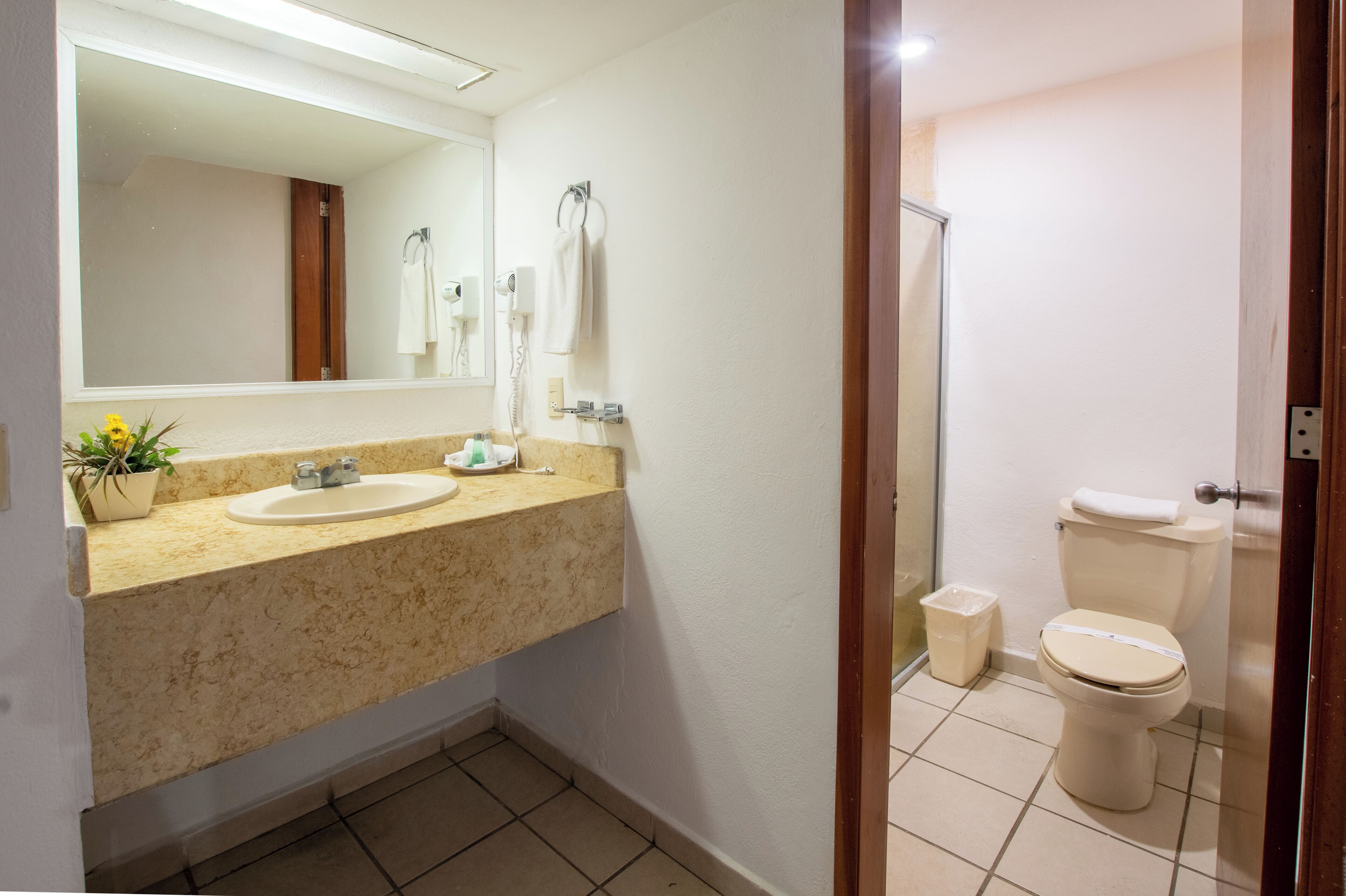 Ein Badezimmer mit Waschbecken, Spiegel und Toilette.