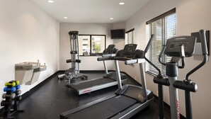 A gym with treadmills, weight machines, and dumbbells. - Staybridge Suites Cedar Rapids North by IHG (Cedar Rapids)