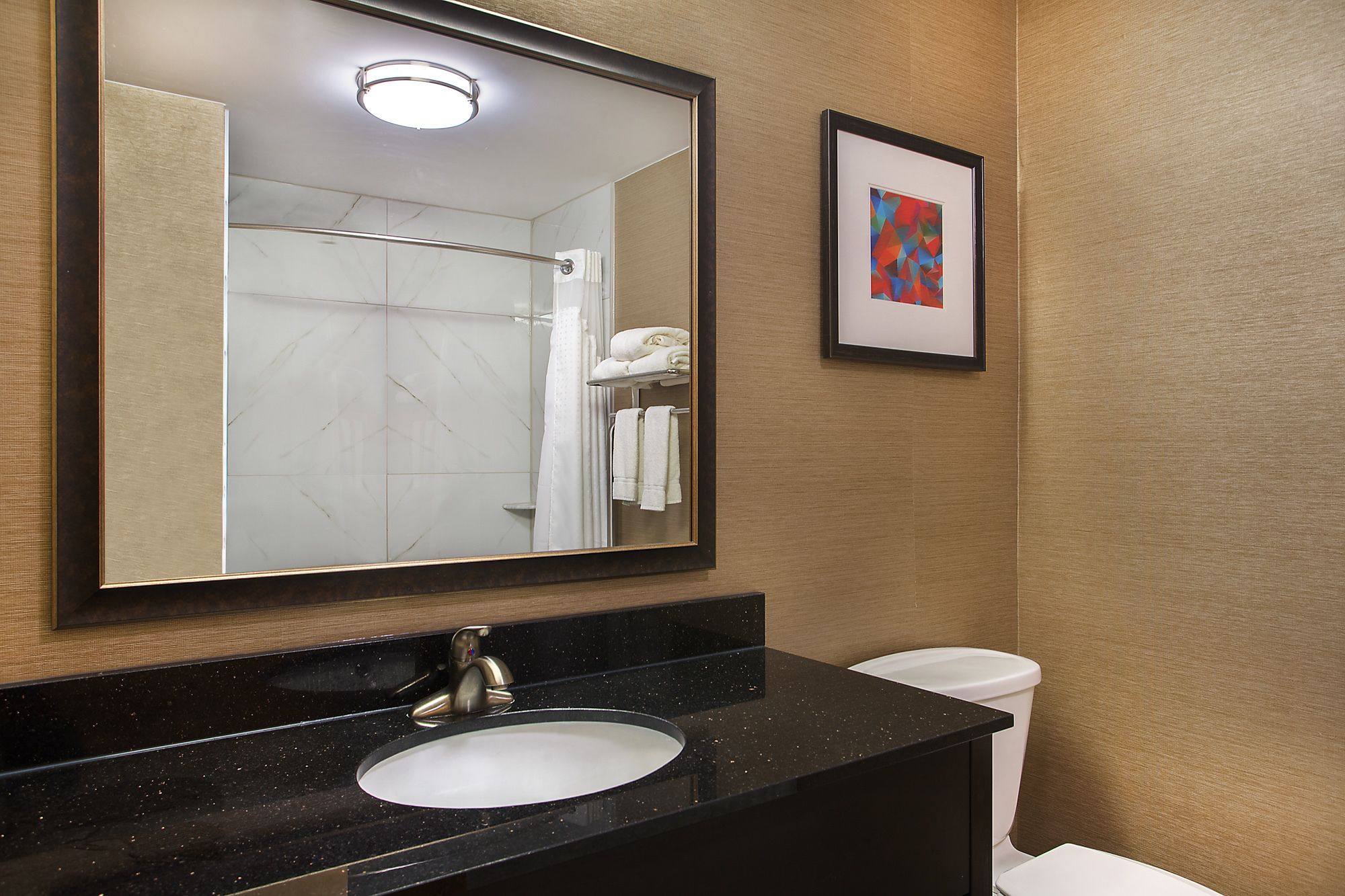 combined shower/bathtub, designer toiletries, hair dryer, towels