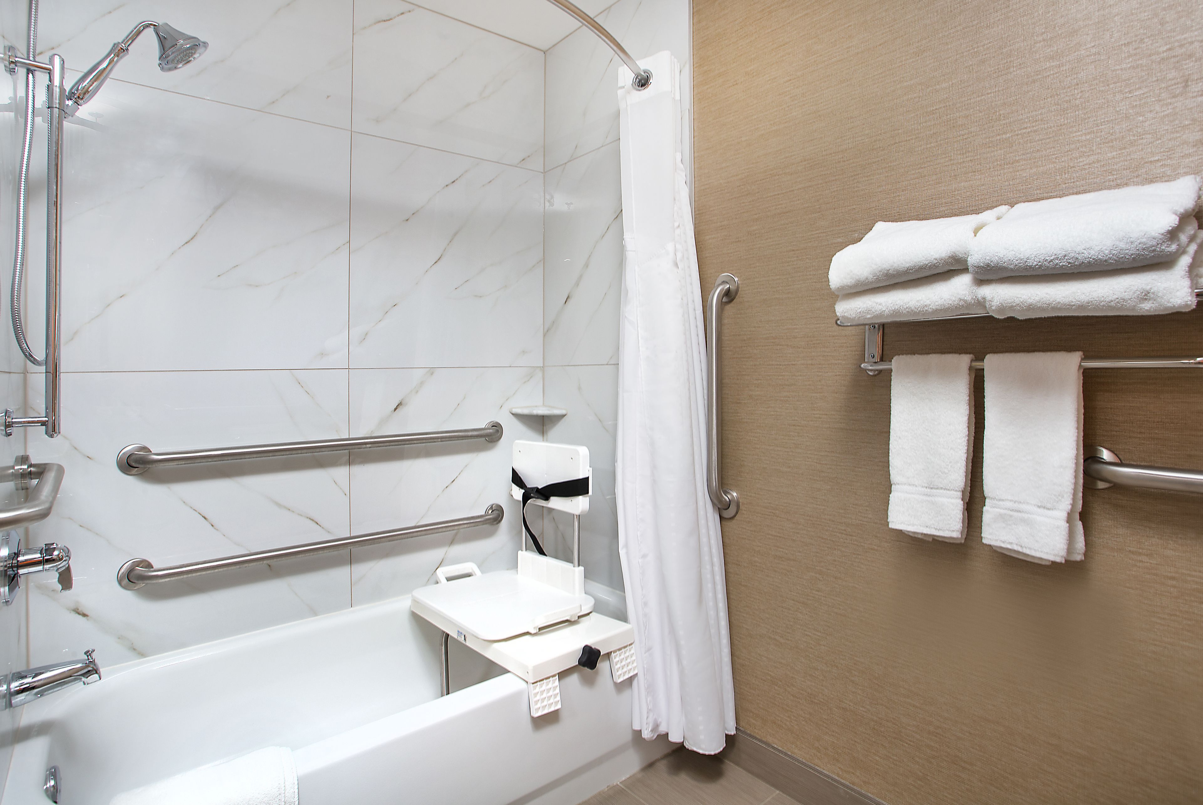 combined shower/bathtub, designer toiletries, hair dryer, towels
