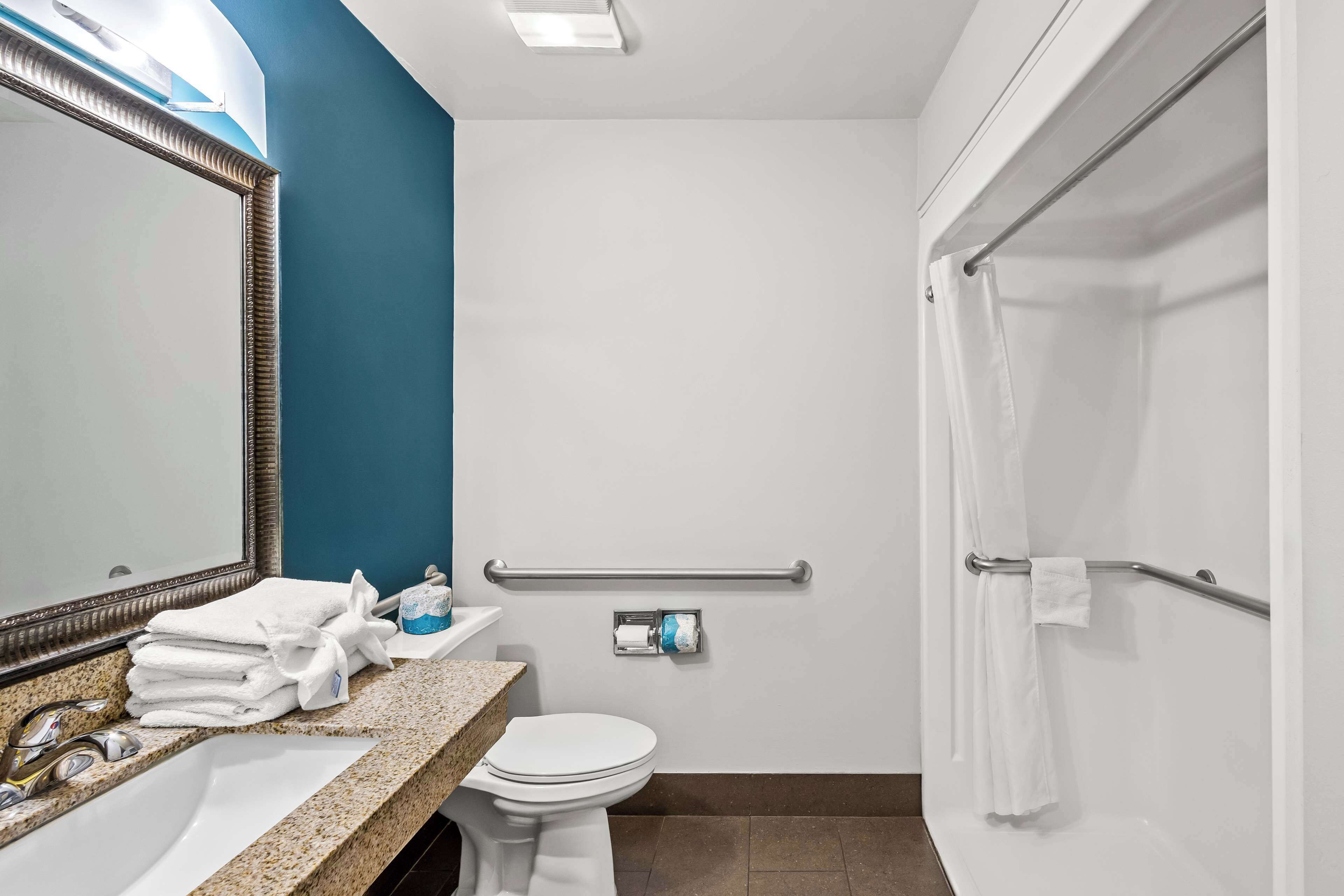 A bathroom with a sink, toilet, and shower.