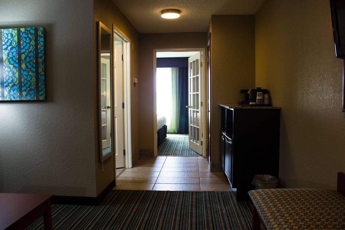 suite, 1 king bed, separate bedroom | desk, iron/ironing board, free cots/infant beds, rollaway beds