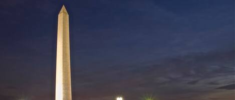 A tall, illuminated monument at night.