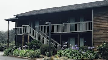 A two-story building with a balcony and a staircase.