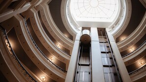 Un atrio de varios niveles con un tragaluz central y múltiples balcones.