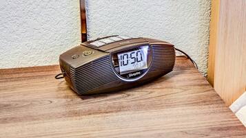 A digital clock radio on a wooden surface.