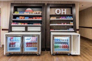 A snack and beverage display with two refrigerated cases, one containing sodas and the other containing beer.