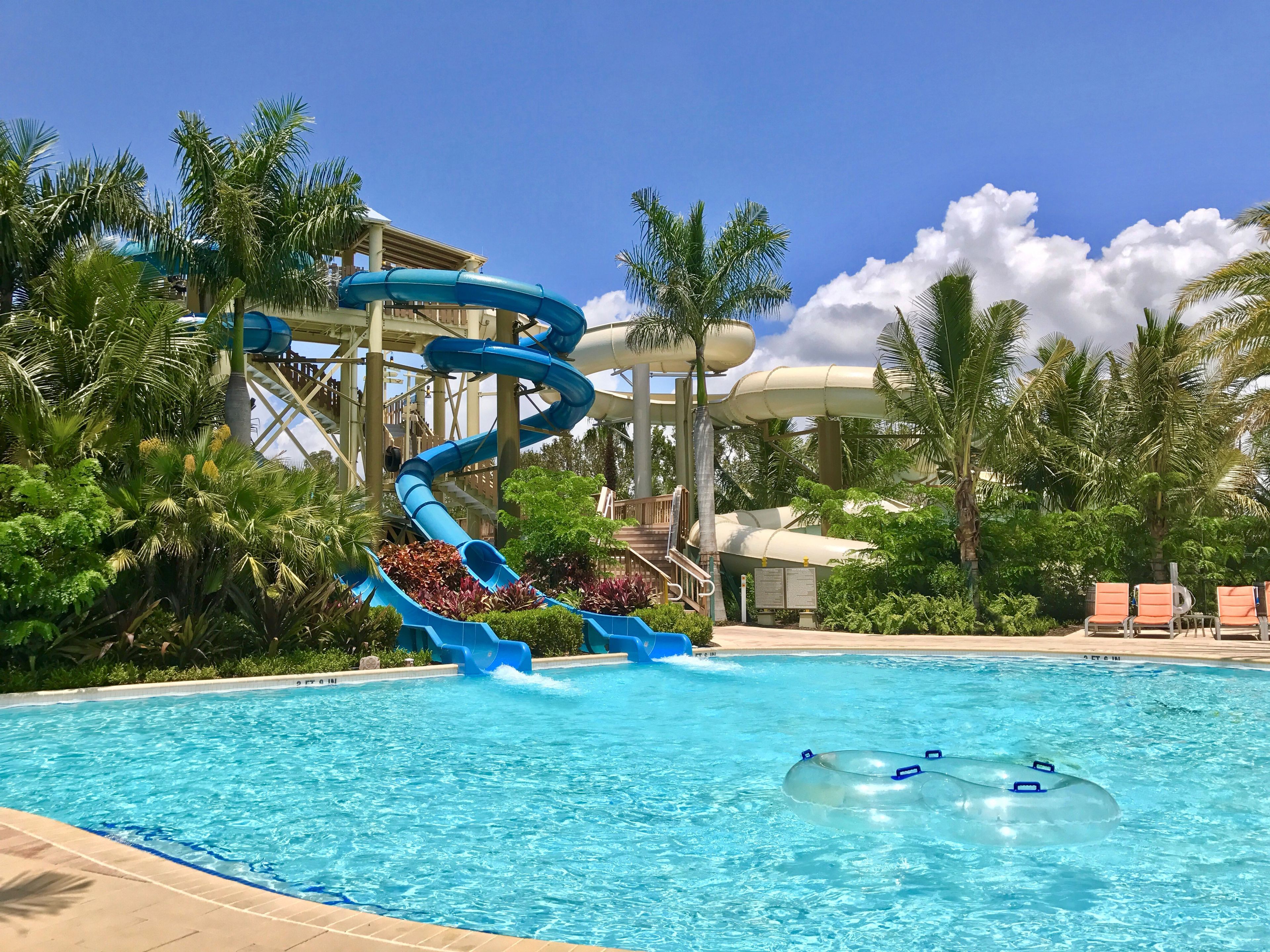 A water park with multiple slides and a pool.