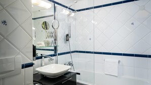 A bathroom with a white sink, a mirror, and a glass shower enclosure. - Arthotel ANA Gala, Trademark Collection by Wyndham (Vienna)