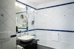 A bathroom with a white sink, a mirror, and a glass shower enclosure. - Arthotel ANA Gala, Trademark Collection by Wyndham (Vienna)