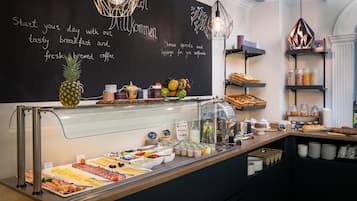 A breakfast buffet with a variety of food options, a chalkboard menu, and a modern interior design.