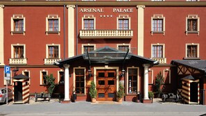 A red building with the sign "ARSENAL PALACE" and a series of windows.