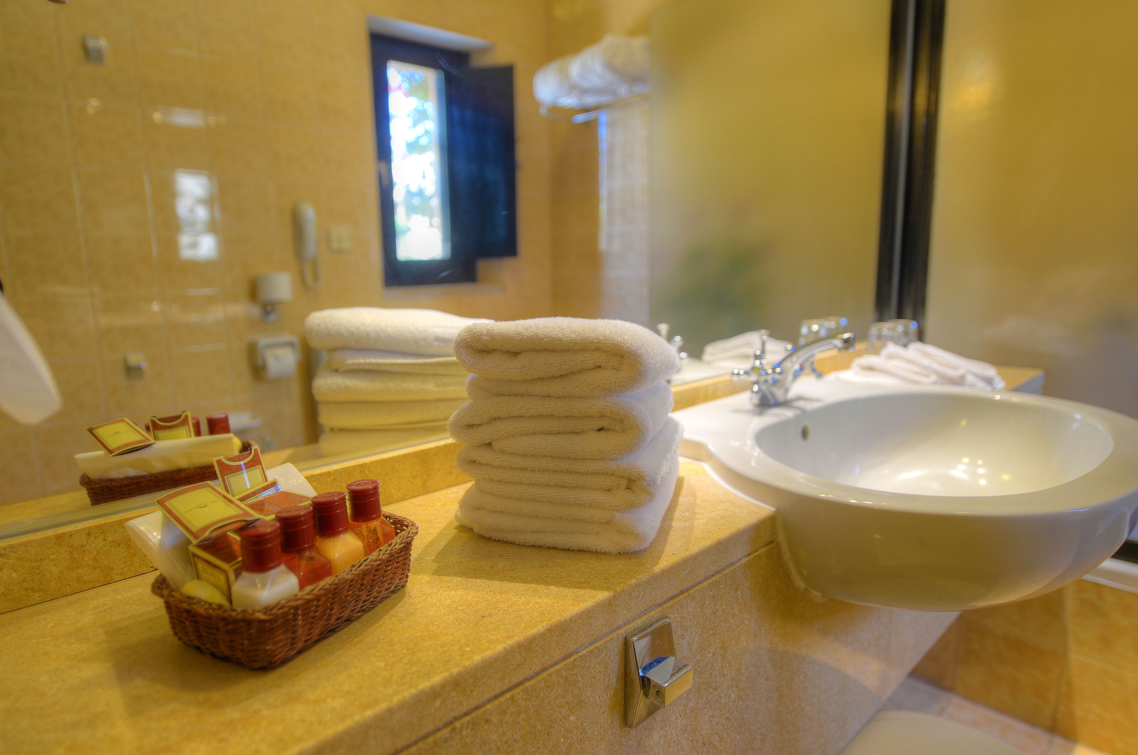 designer toiletries, hair dryer, bathrobes, slippers