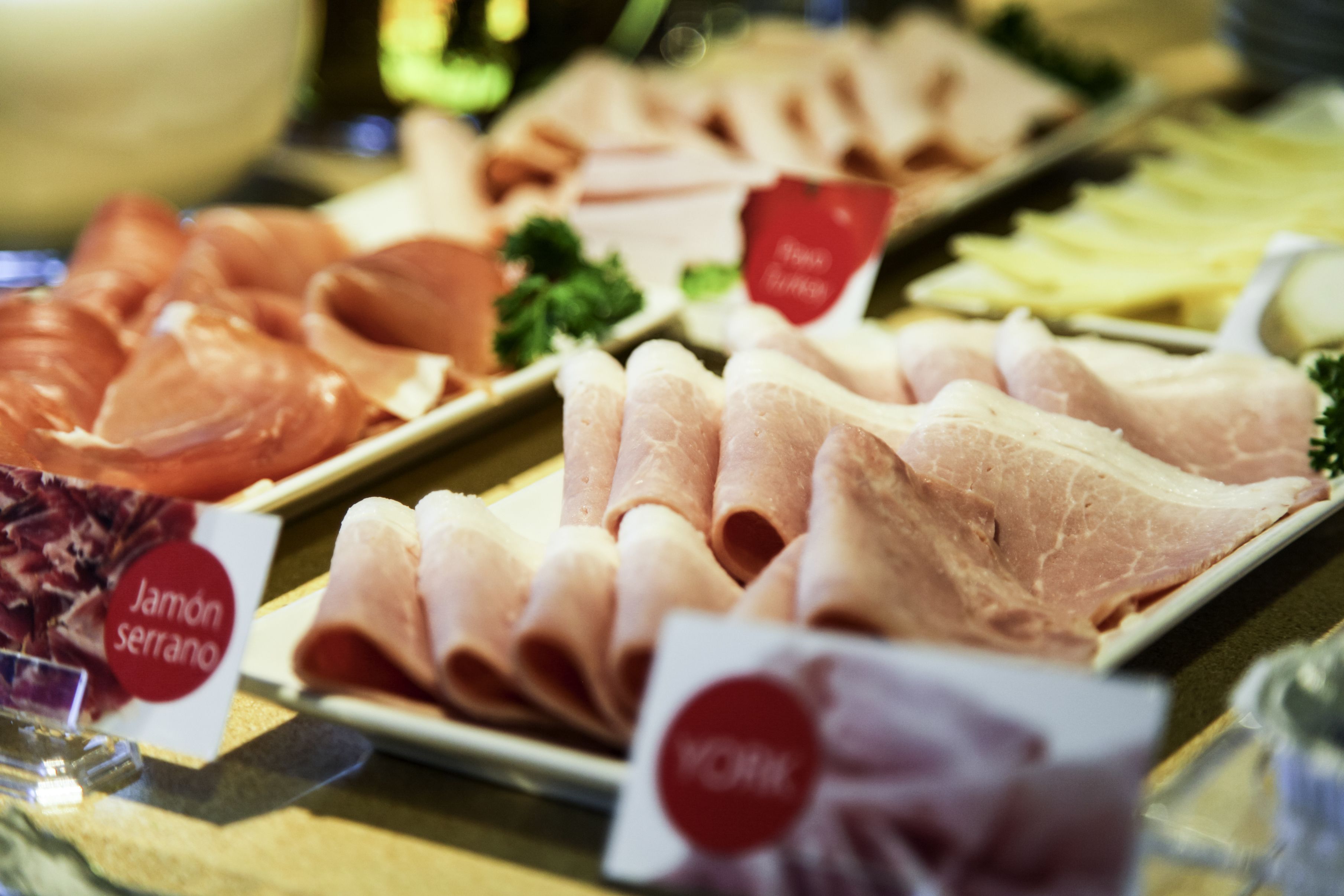 A variety of meats displayed on a table with labels.
