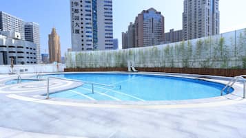 Seasonal outdoor pool, open 8:00 AM to 9:00 PM, pool umbrellas