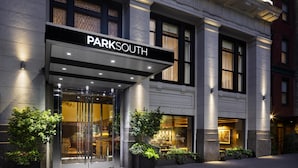 A hotel entrance with a 'PARKSOUTH' sign, large glass doors, and potted plants. - Park South Hotel, part of JdV by Hyatt (New York)