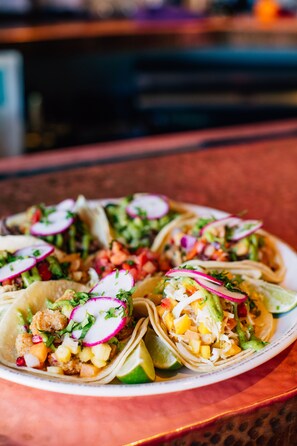 A plate of tacos with various toppings.