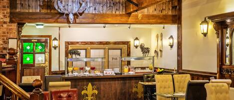 A restaurant interior with wooden beams, a bar area, and seating arrangements.