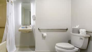 A bathroom with a toilet, sink, and shower curtain.