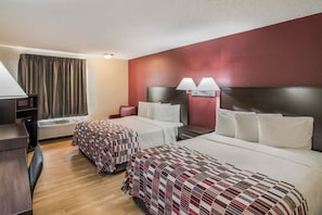 A hotel room with two beds, a desk, a chair, a TV, and a window with curtains. - Red Roof Inn & Suites Pensacola East - Milton (Milton)