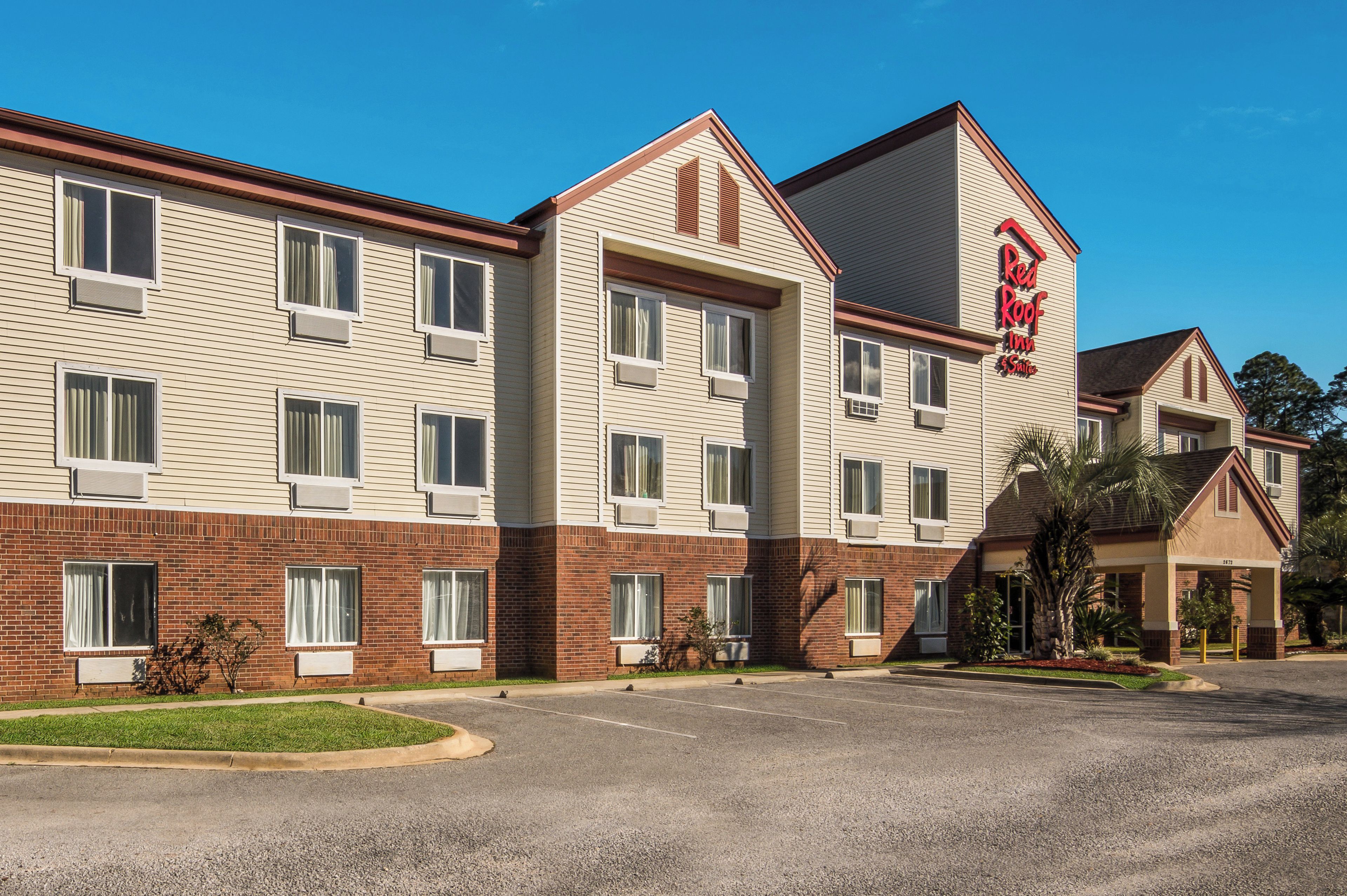A multi-story hotel with a brick facade and a flat roof.