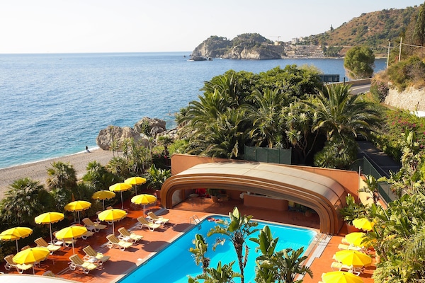 Seasonal outdoor pool, open 9:00 AM to 6:00 PM, pool umbrellas