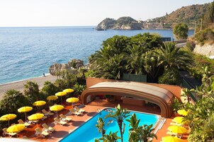 Seasonal outdoor pool, open 9:00 AM to 6:00 PM, pool umbrellas