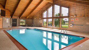 An indoor swimming pool with clear glass walls, wooden beams, and a tiled floor. - Quality Inn Bolingbrook I-55 (Bolingbrook)