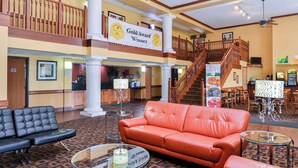 A lobby with a reception desk, a staircase, and seating areas. - Quality Inn Bolingbrook I-55 (Bolingbrook)