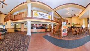 A spacious lobby with a fireplace, a seating area, a reception desk, and a staircase leading to an upper level. - Quality Inn Bolingbrook I-55 (Bolingbrook)
