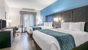 A hotel room with two beds, a desk, a TV, and a window with curtains. - Comfort Inn Gainesville - University Area (Gainesville)