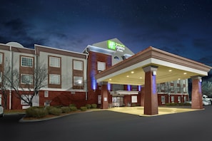 A Holiday Inn Express & Suites hotel with a covered entrance and brick facade.