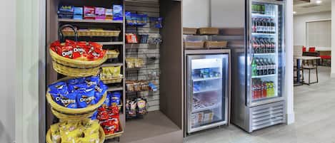 A snack and beverage vending area with various snacks and drinks.