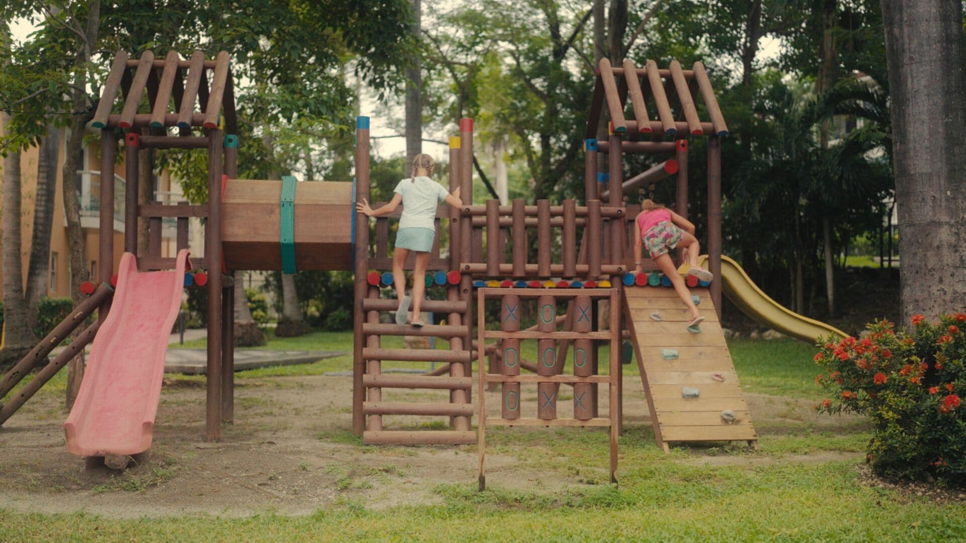 A playground with climbing structures, slides, and a wooden play area.