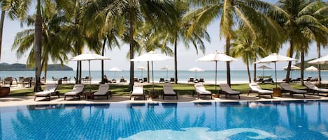 Piscine extérieure, parasols de plage, chaises longues