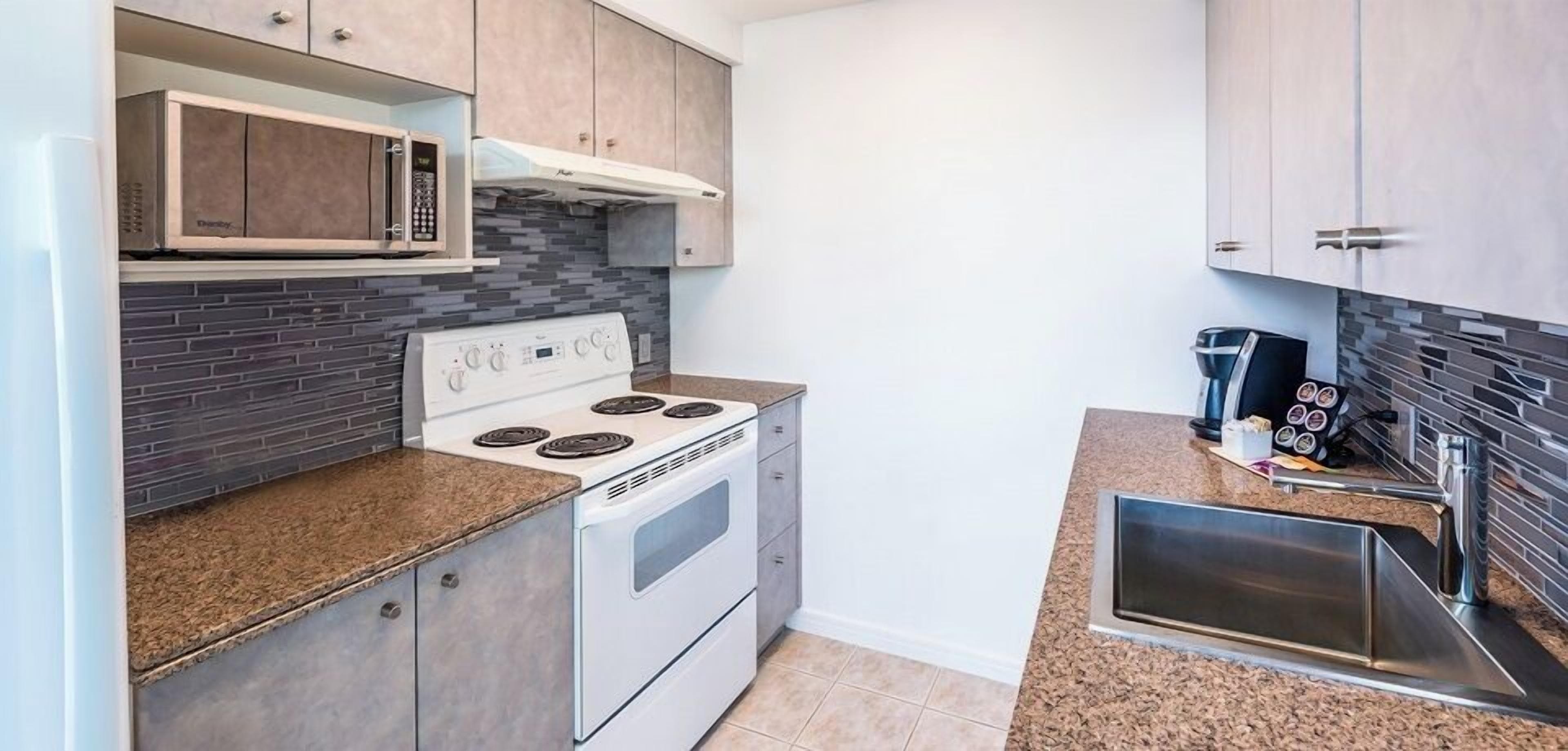 standard 1-bedroom suite (1 king) | private kitchen | fridge, microwave, oven, stovetop