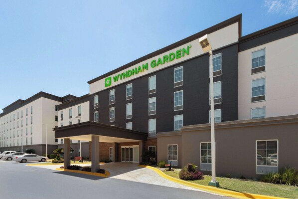 A Wyndham Garden hotel with a modern facade, multiple floors, and a covered entrance area. - Wyndham Garden Monterrey Aeropuerto (Apodaca)