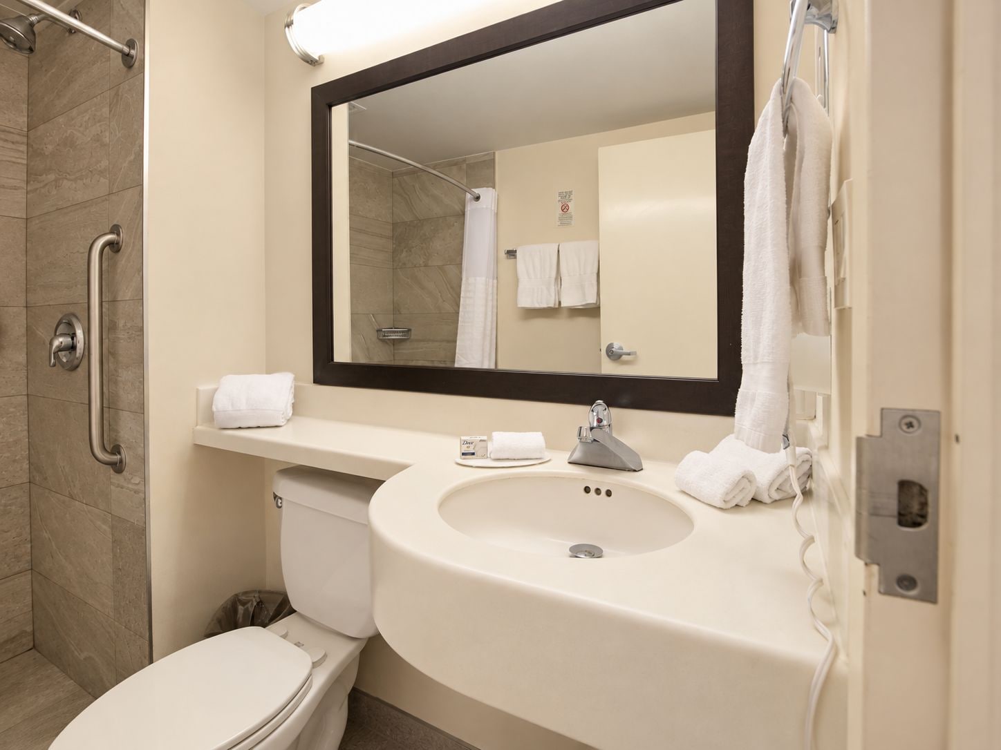 A bathroom with a toilet, sink, and shower.