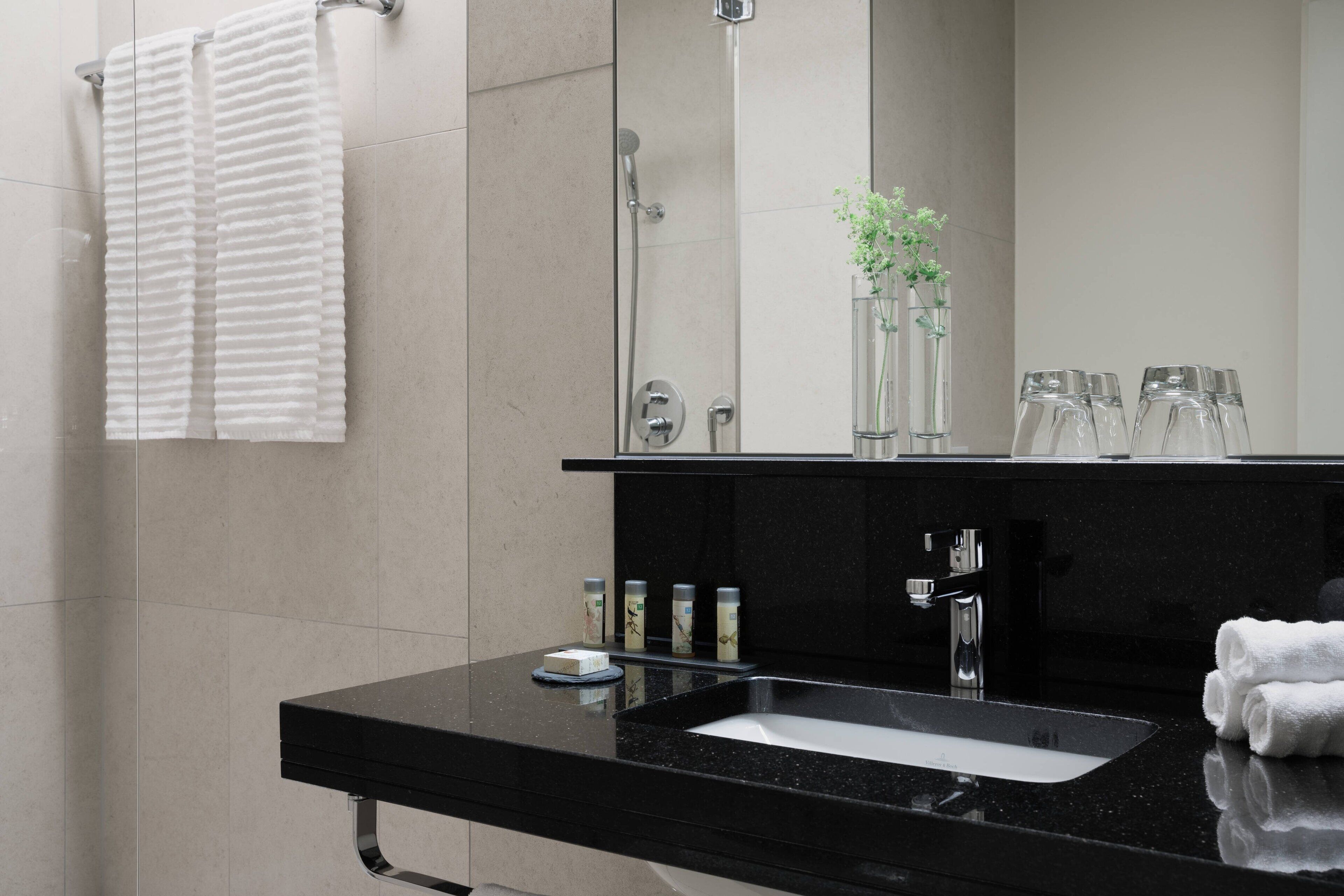 shower, designer toiletries, hair dryer, towels