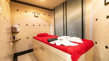 Cozy retreat with a single bed, modern design, and a shelf unit for your essentials.