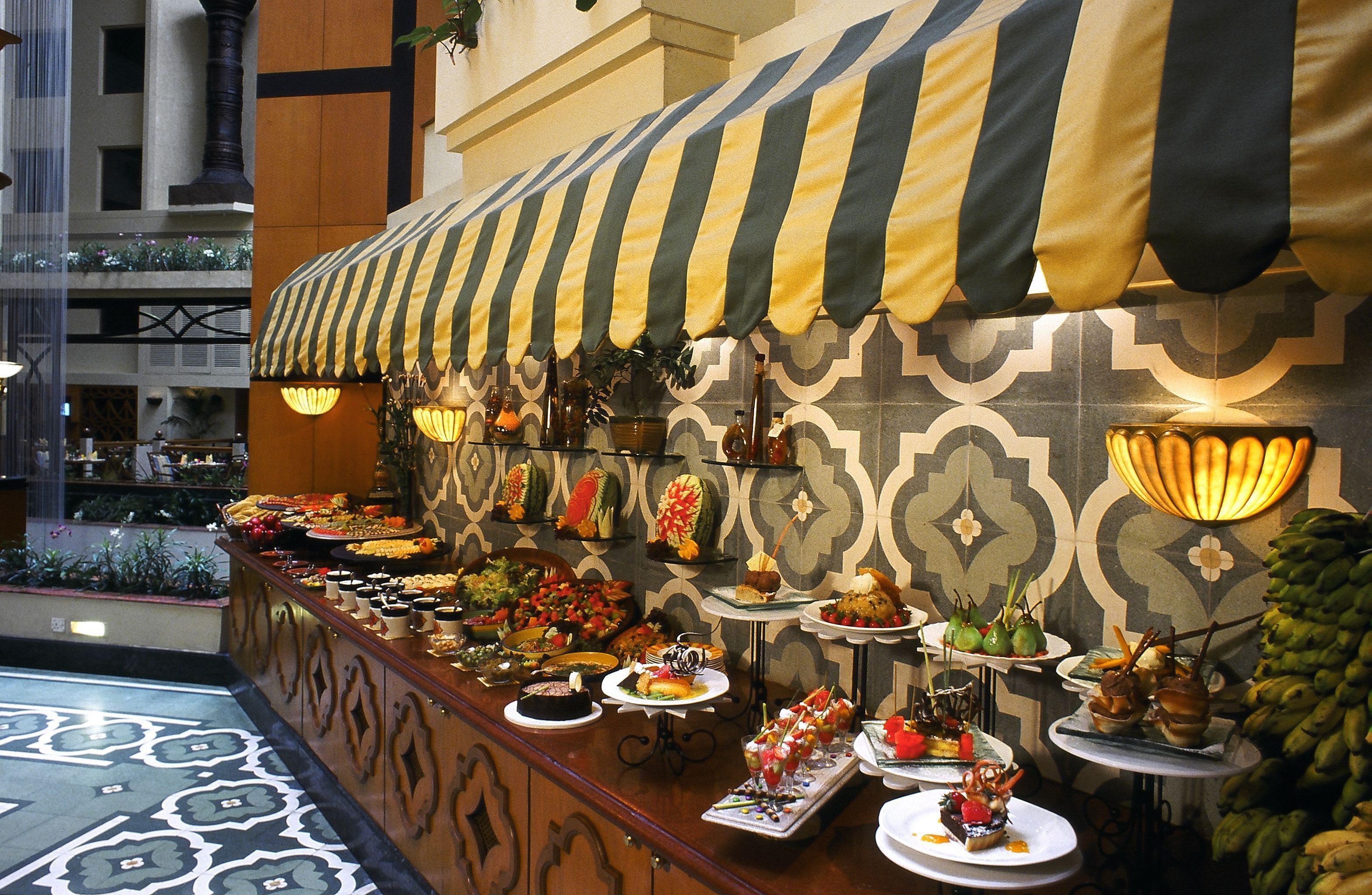 A buffet with a variety of dishes and a decorative canopy.