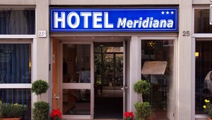 A hotel entrance with a blue sign reading "HOTEL Meridiana". - Hotel Meridiana (Florence)
