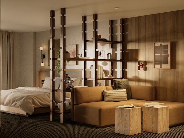 Una habitación de hotel moderna con un separador de madera, un sofá, una cama y una pequeña mesa de madera.